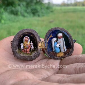 Miniature nativity scene inside a walnut, mini shepherd with mini farm animals